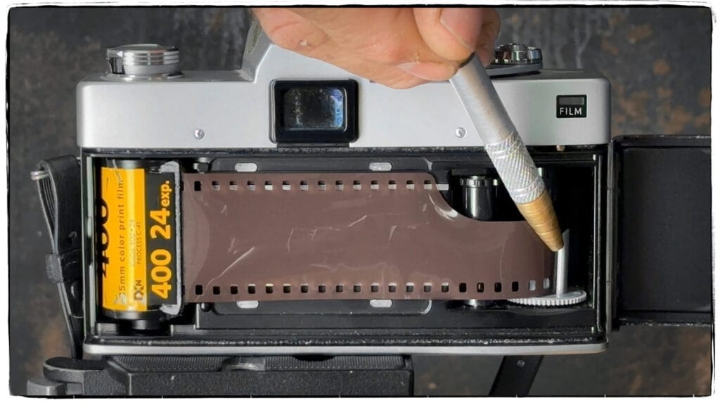 Image of how to load film into a single lens reflex camera.