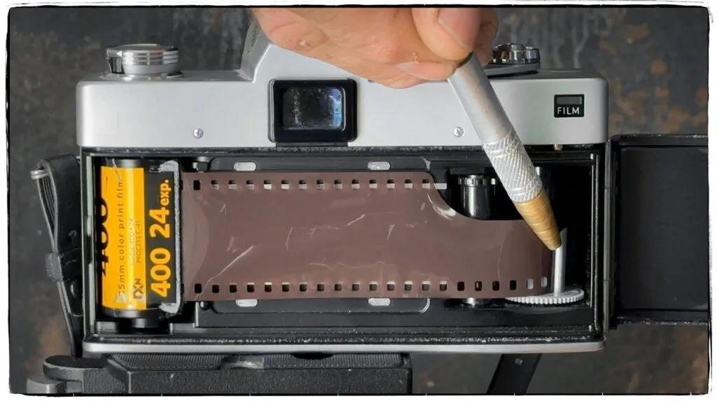 Image of how to load film into a single lens reflex camera.