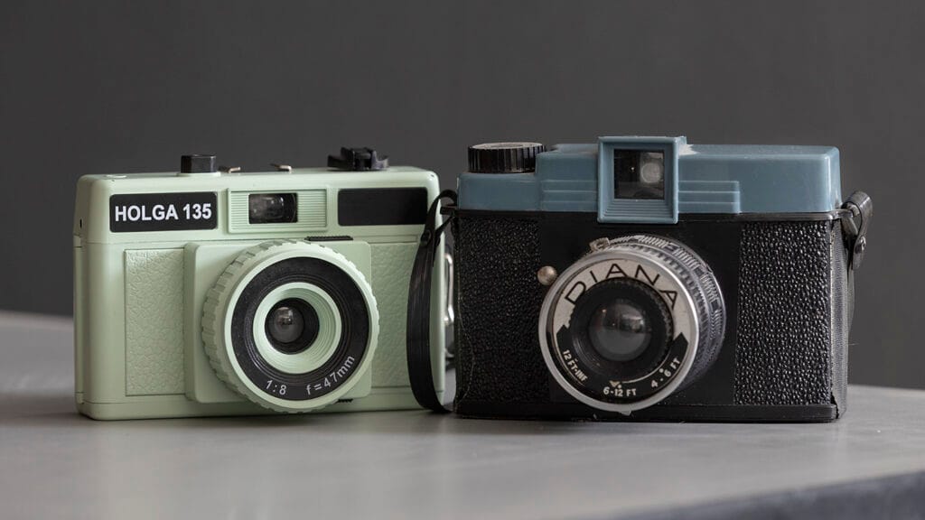 View of a 35mm Holga camera on the left and a Diana 120 camera on the right.